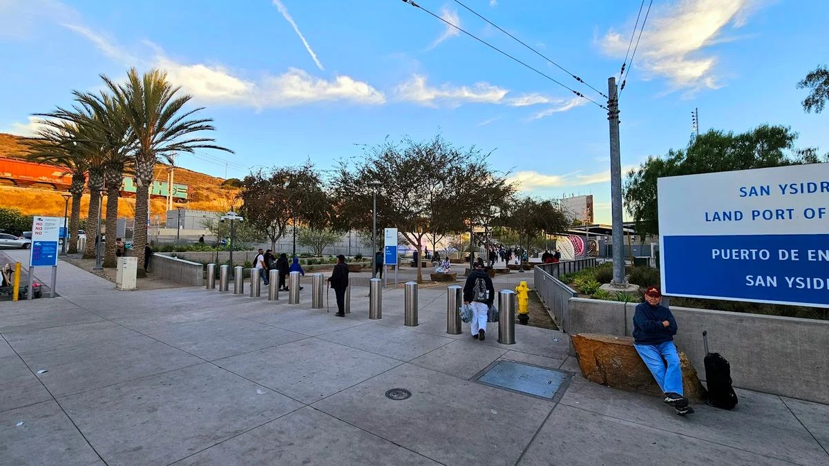 Pedestrians and travelers using accessible walking paths and seating areas near the San Ysidro Land Port of Entry