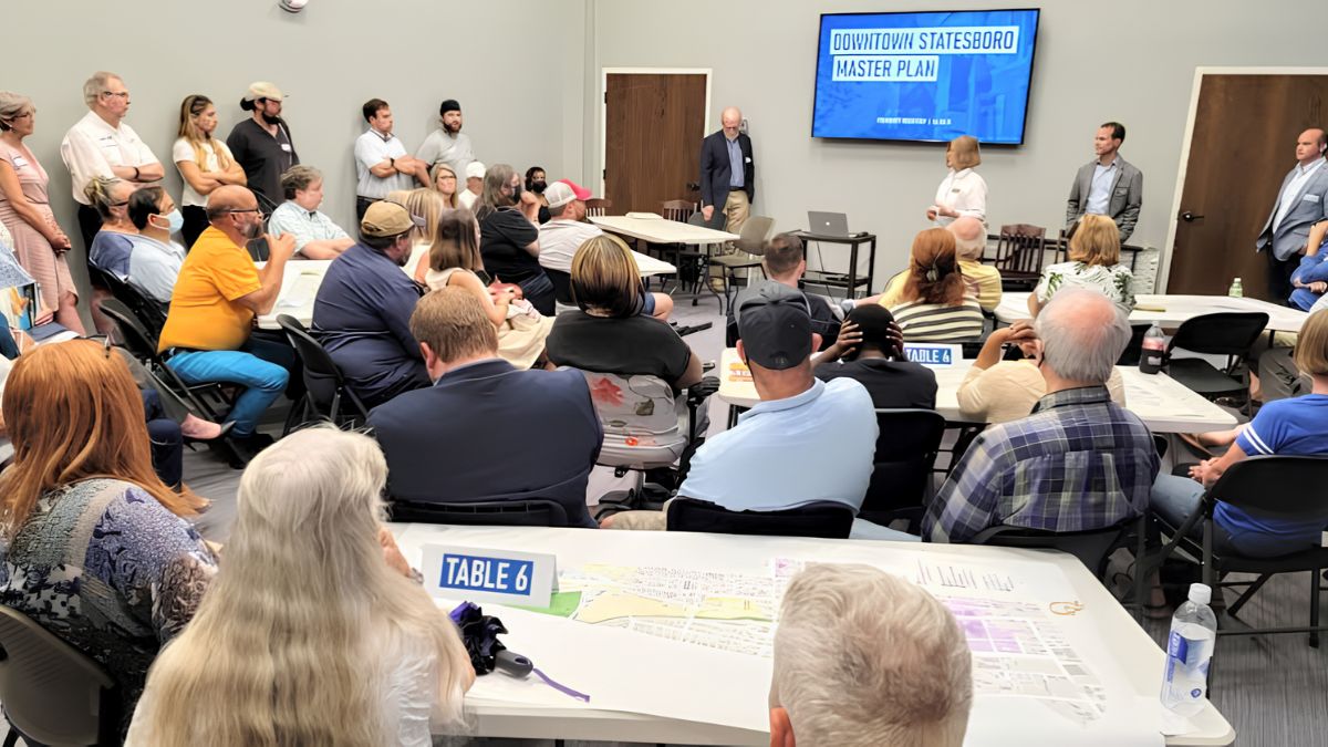 Community members attending a public planning meeting and listening to a presentation about a master plan.