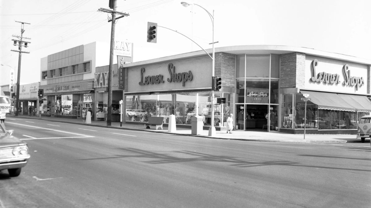 Vintage black and white street view of old storefronts including Lerner Shops and Kay Jewelers