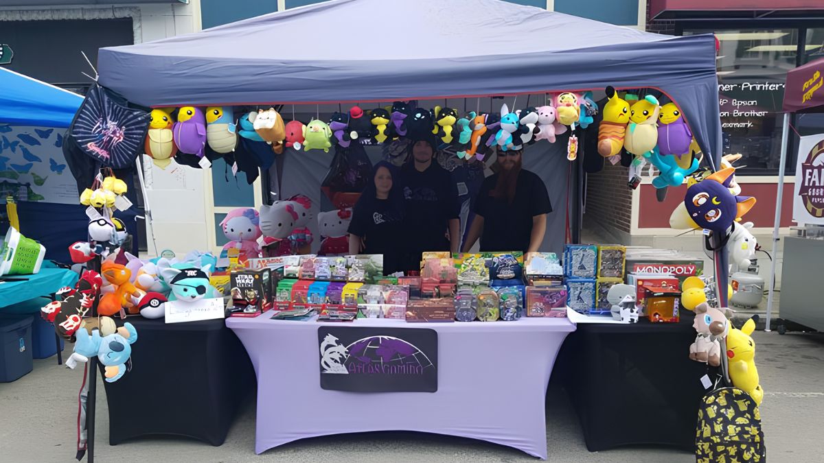 A vendor booth at a San Ysidro local community event displaying plush toys and card games, showcasing how small businesses connect with customers.