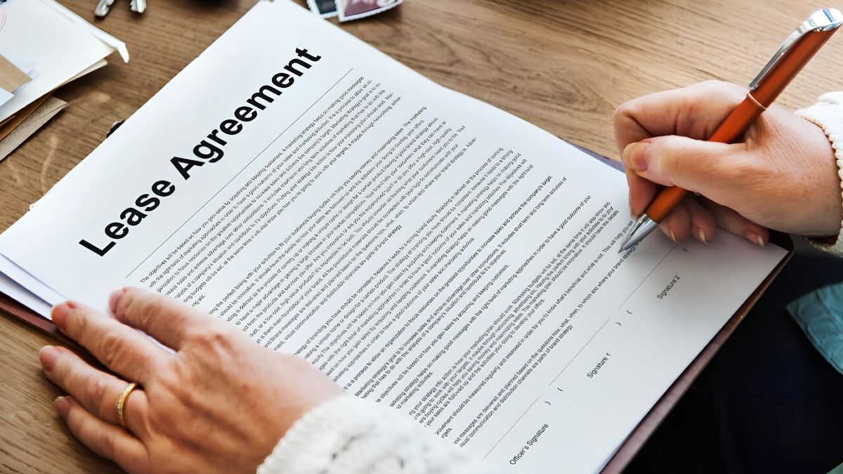 Close-up of a person signing a commercial lease agreement document for a new small business shop.