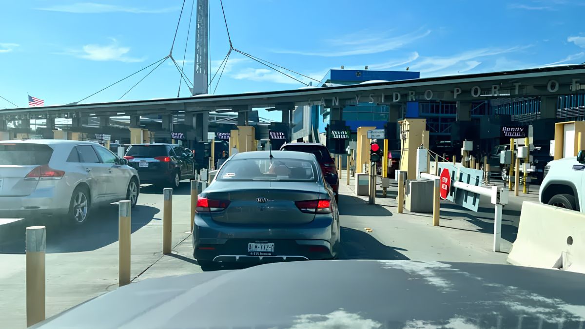 Cars lined up in inspection lanes at the San Ysidro border checkpoint during daytime before embarking on a road trip