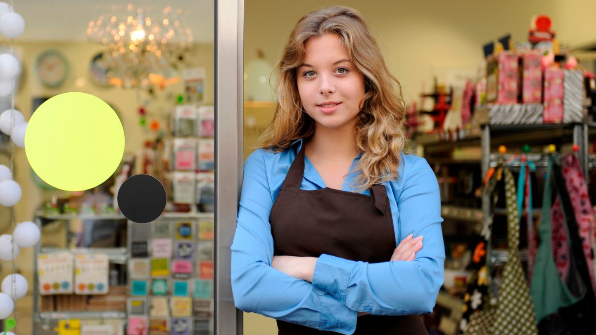 A smiling shop owner standing proudly in the doorway of her retail store in San Ysidro