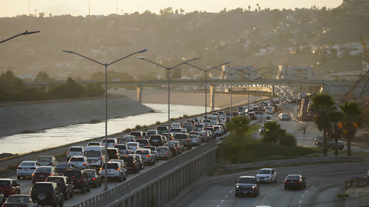 Heavy traffic on a multi-lane highway leading toward the border area, illustrating travel between San Diego and Tijuana with potential delays.