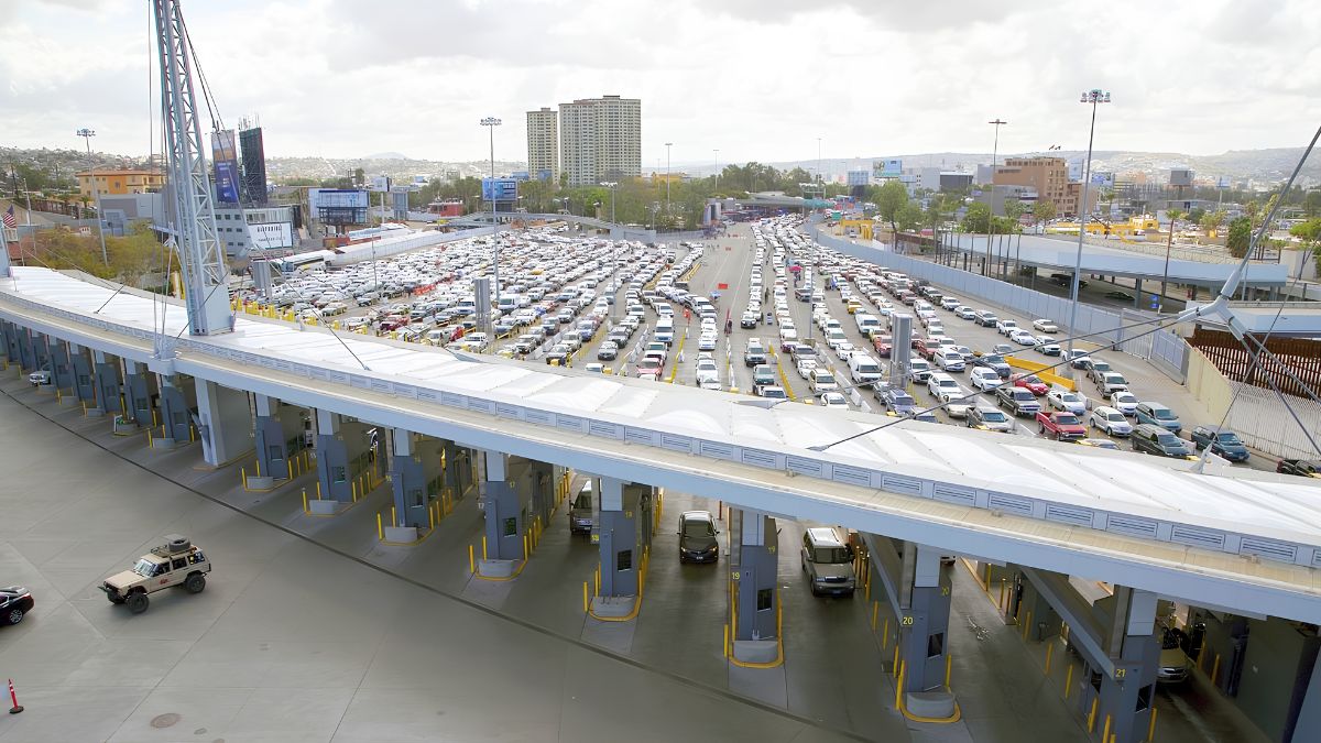Aerial view of vehicle lanes and inspection booths packed with cars at the San Ysidro border crossing.