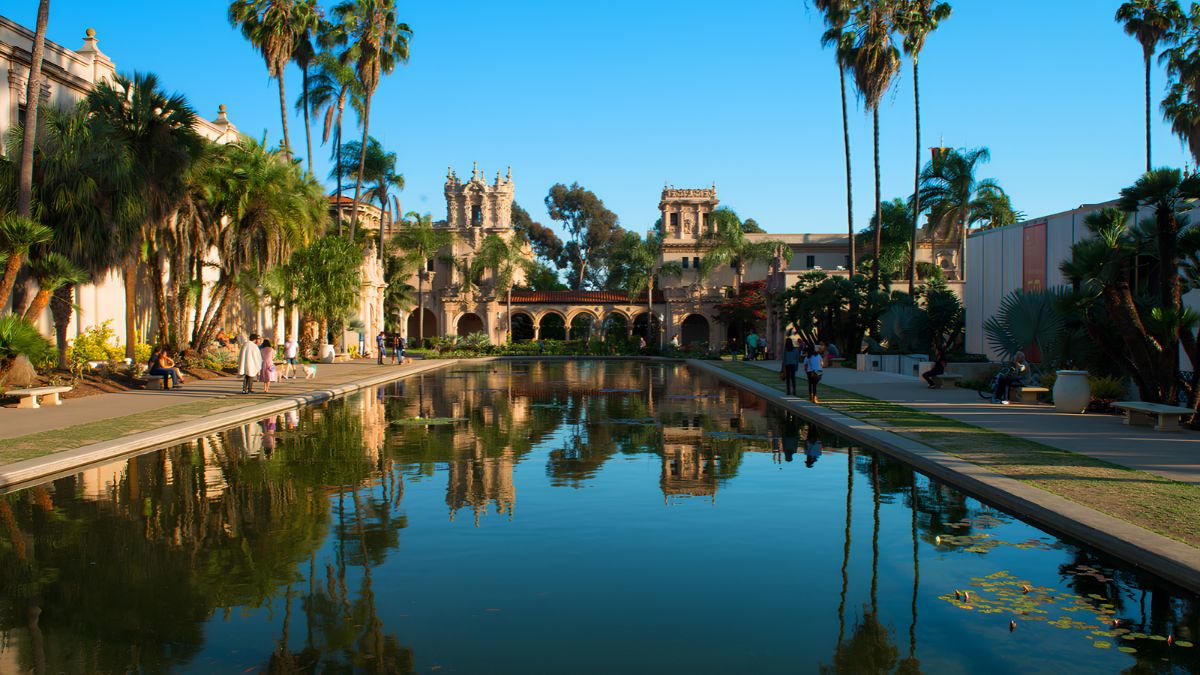 Historic architecture surrounded by palm trees and a reflecting pool, highlighting San Ysidro's rich building heritage.