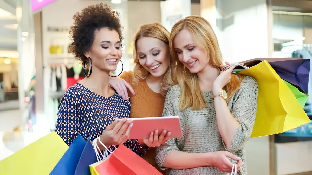 A shopper carefully inspecting a clearance and final-sale clothing item in a store to check its quality and fit before purchasing.