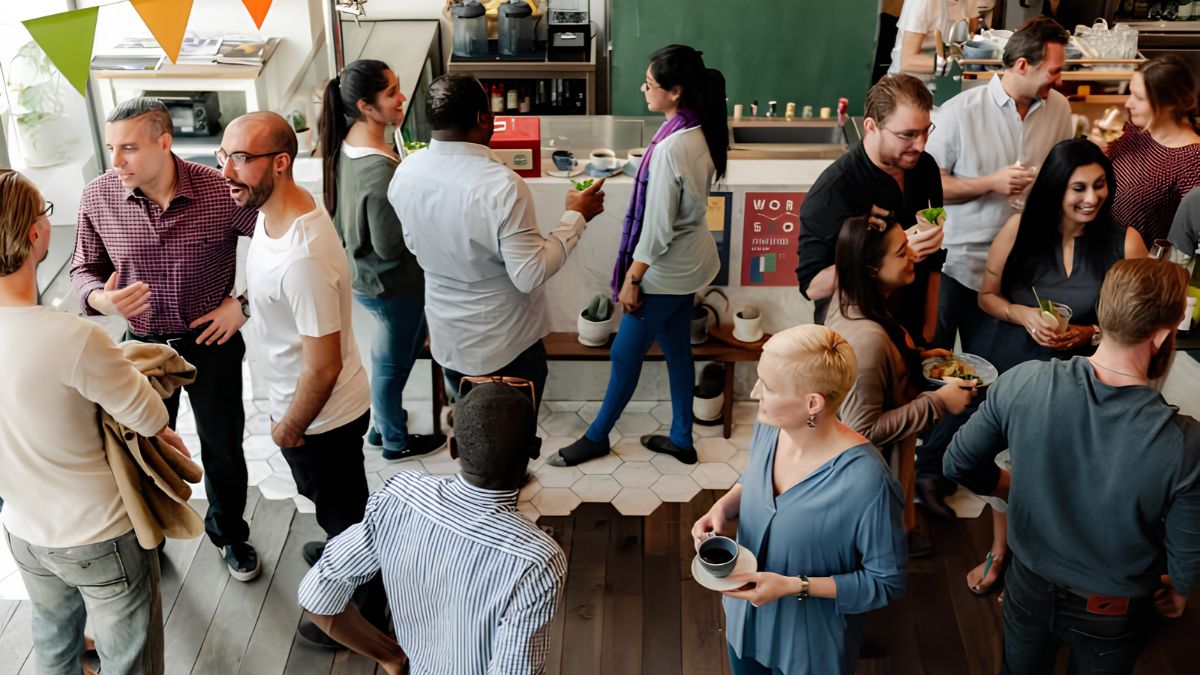 Diverse group of local customers and business owners networking and socializing inside a bustling cafe, representing community engagement and small business growth